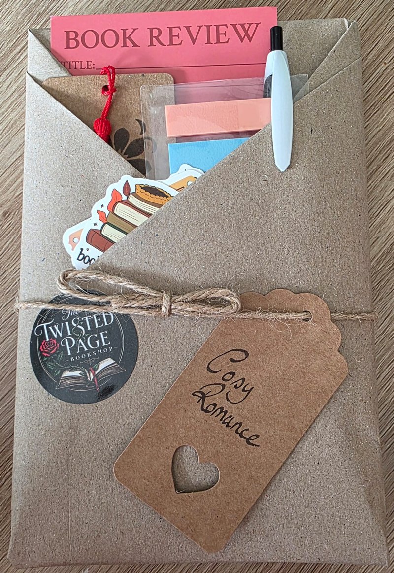 Blind Date with a Book, Cosy Romance pick — a kraft-paper wrapped parcel tied with twine, with a heart-cutout "Cosy Romance" gift tag