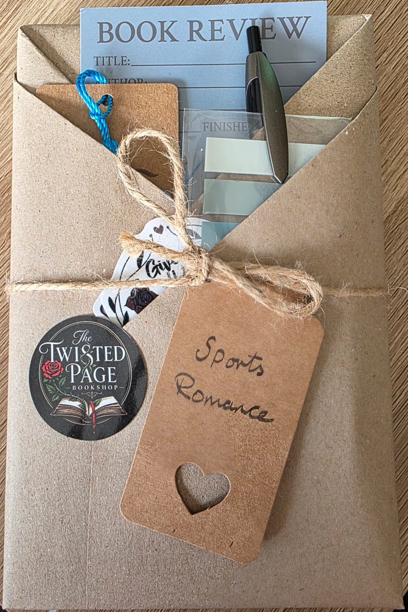 Blind Date with a Book, Sports Romance pick — a kraft-paper wrapped parcel tied with twine, with a heart-cutout "Sports Romance" gift tag